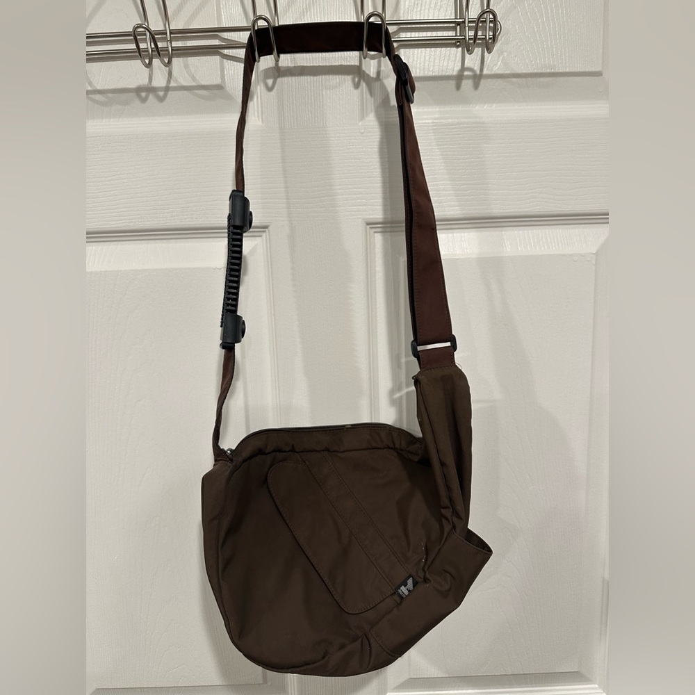 Brown Crossbody Bag with multiple zippered/open compartments.